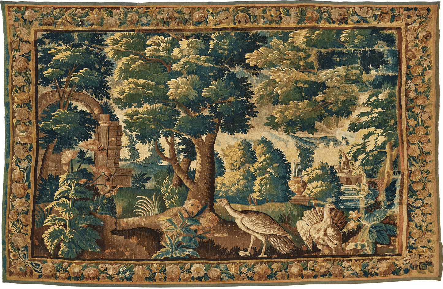 This verdure tapestry is a striking representation of a bucolic landscape, exquisitely crafted to bring the tranquility of nature into any room. The scene unfolds with towering trees and vibrant greenery, meticulously woven to capture the essence of a secluded grove. A quaint stone archway leads to a serene water feature, further enhancing the peacefulness of the tableau. re588996