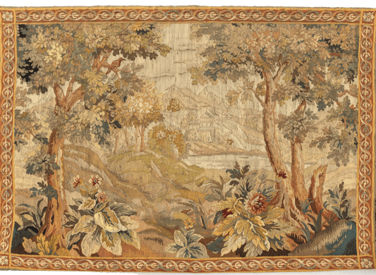A reproduction of an 18th Century Flemish verdure tapestry featuring a serene landscape with stately trees, exotic birds, and blooming flora, enclosed in an ornate border.
