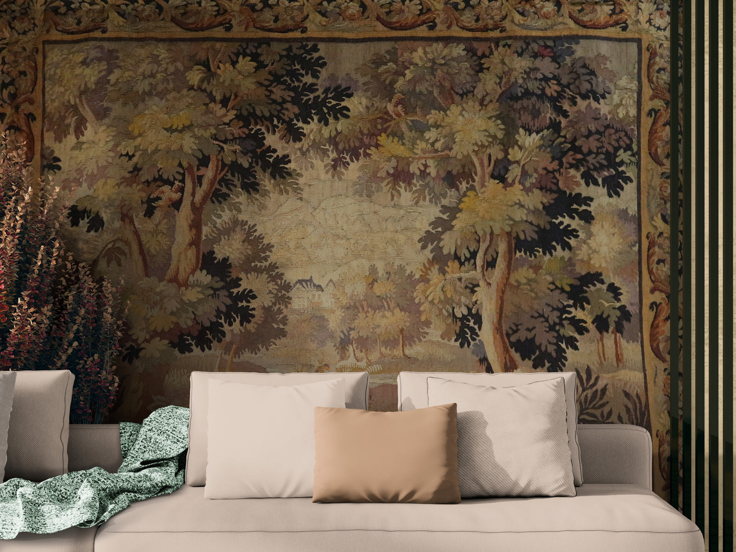 Decorative tapestry with a forest scene above a beige sofa with pillows.