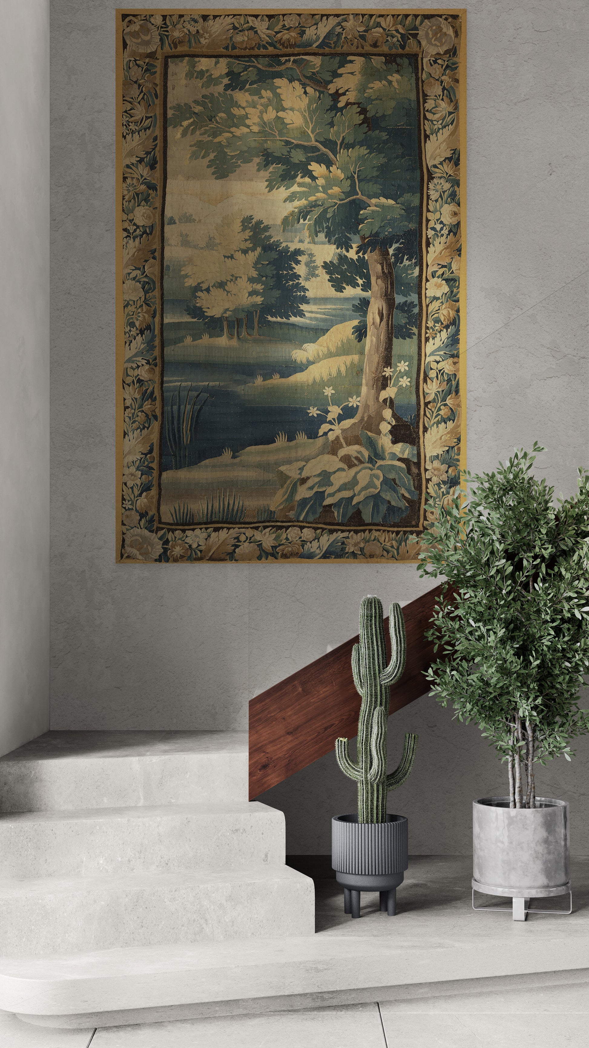A large framed landscape tapestry featuring a tree and river scene, displayed on a gray wall above a staircase with potted plants.