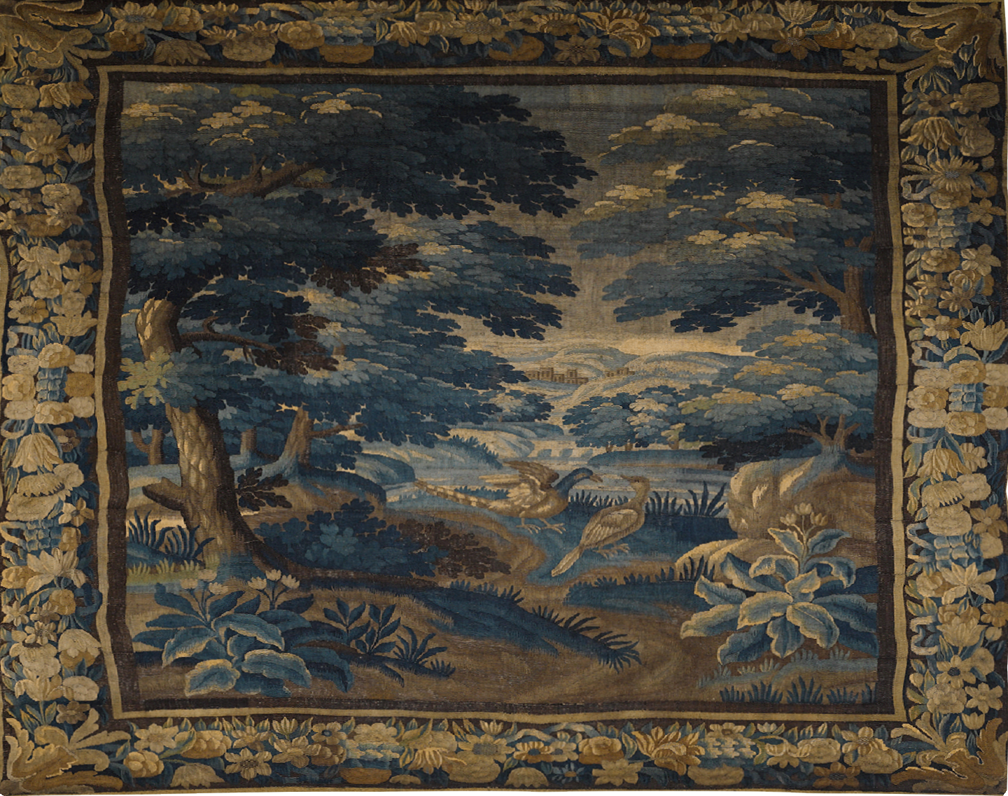 Decorative tapestry with a landscape scene featuring trees, birds, and flowers.