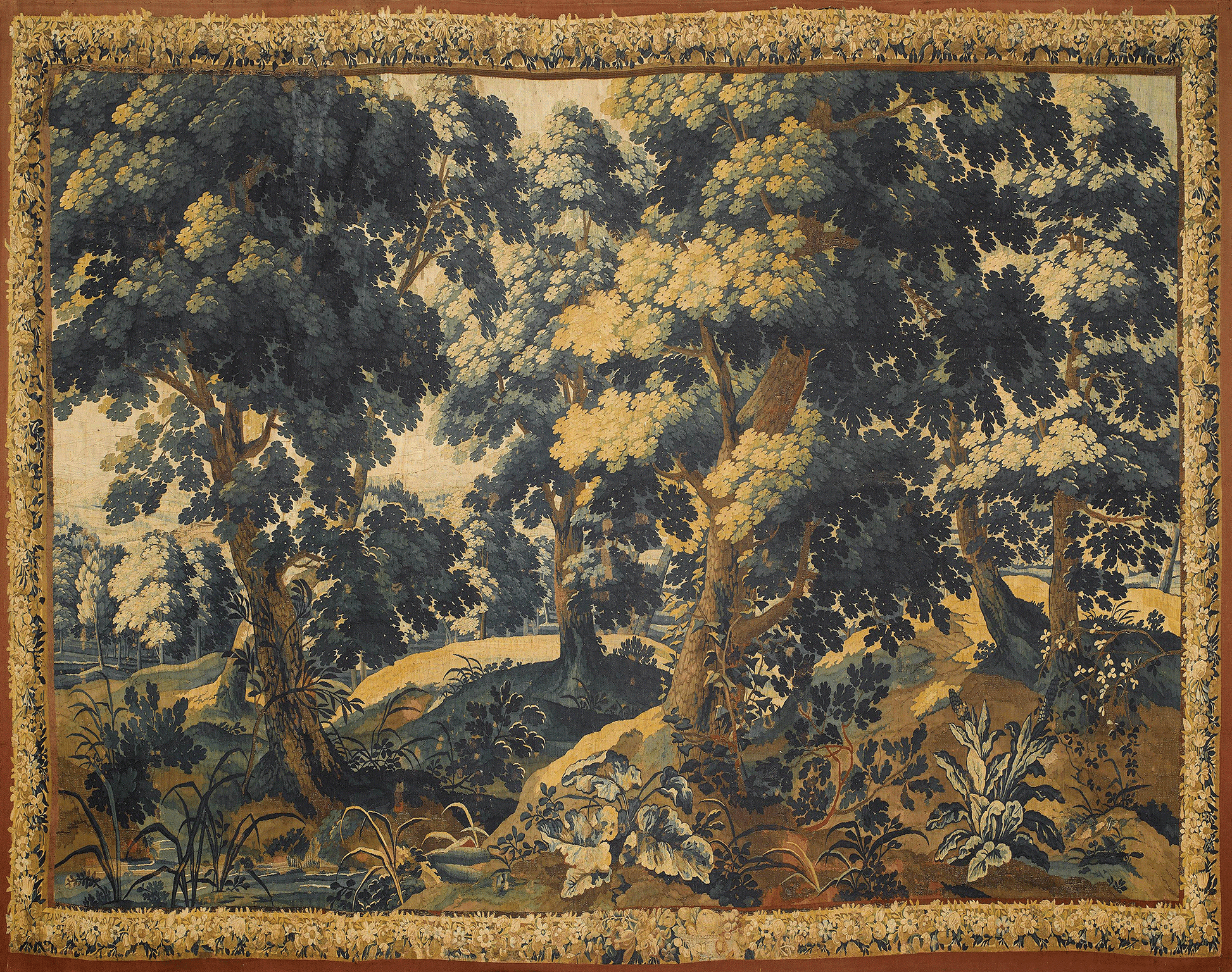 Tapestry depicting a forest scene with trees and undergrowth.