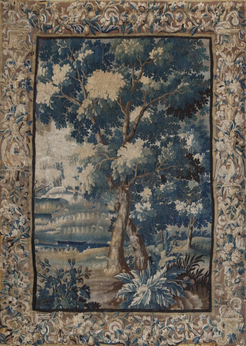 Decorative tapestry with a tree and landscape design, framed by intricate border patterns.