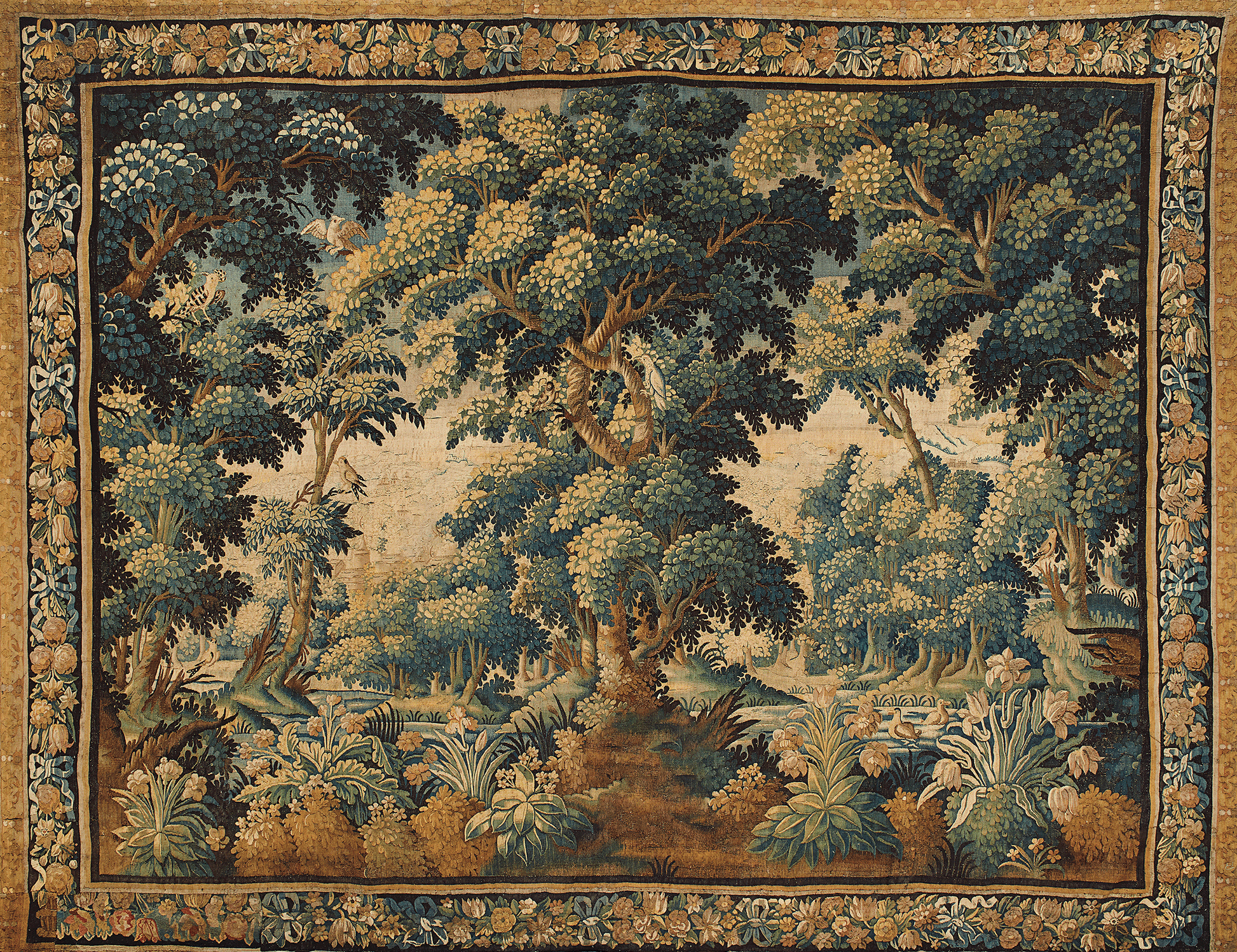 Decorative tapestry with a forest scene and intricate border