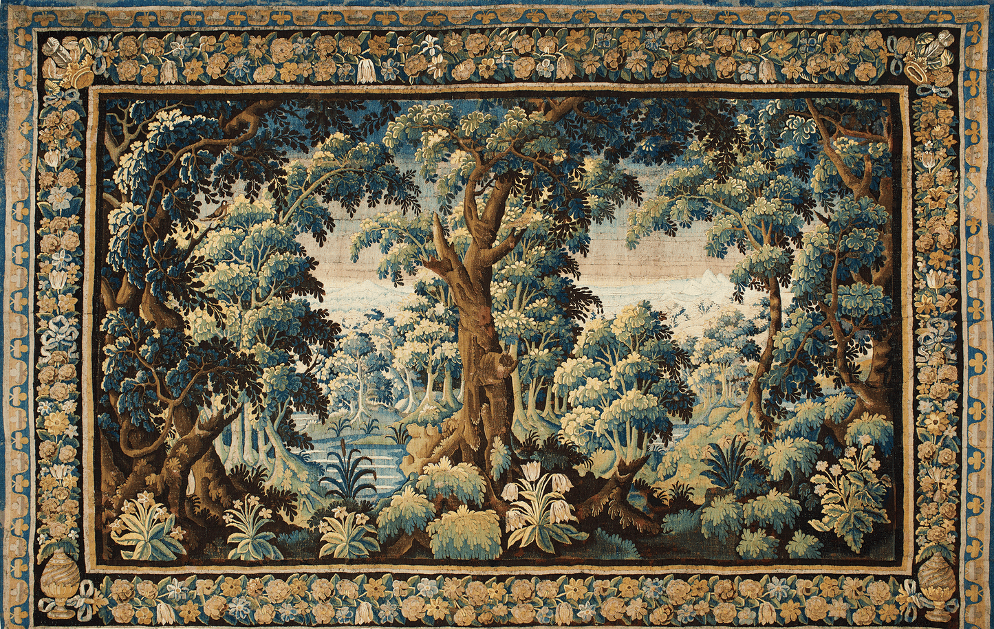 Tapestry with a forest scene and decorative border