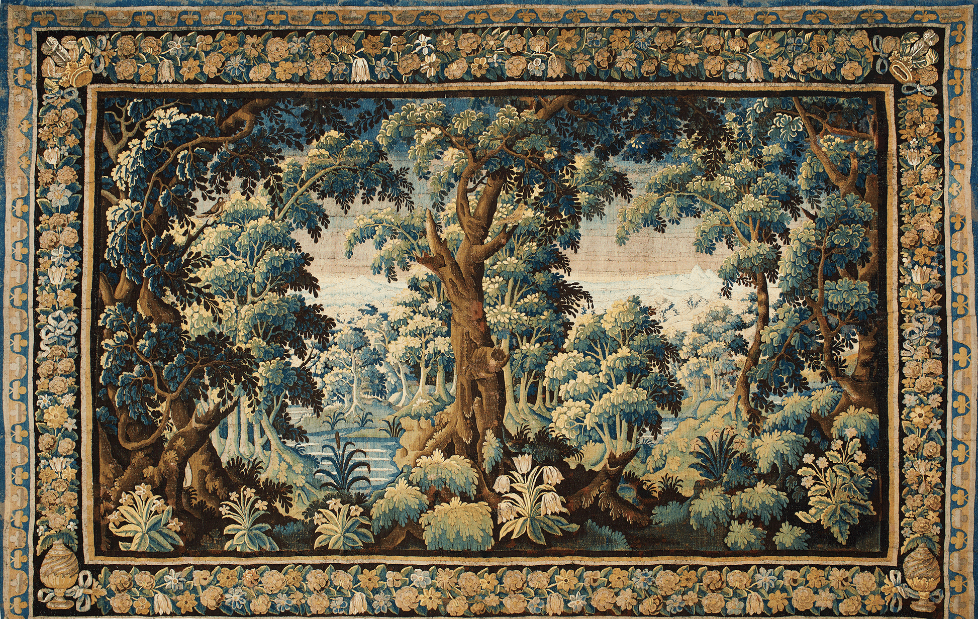 Tapestry with a forest scene and decorative border