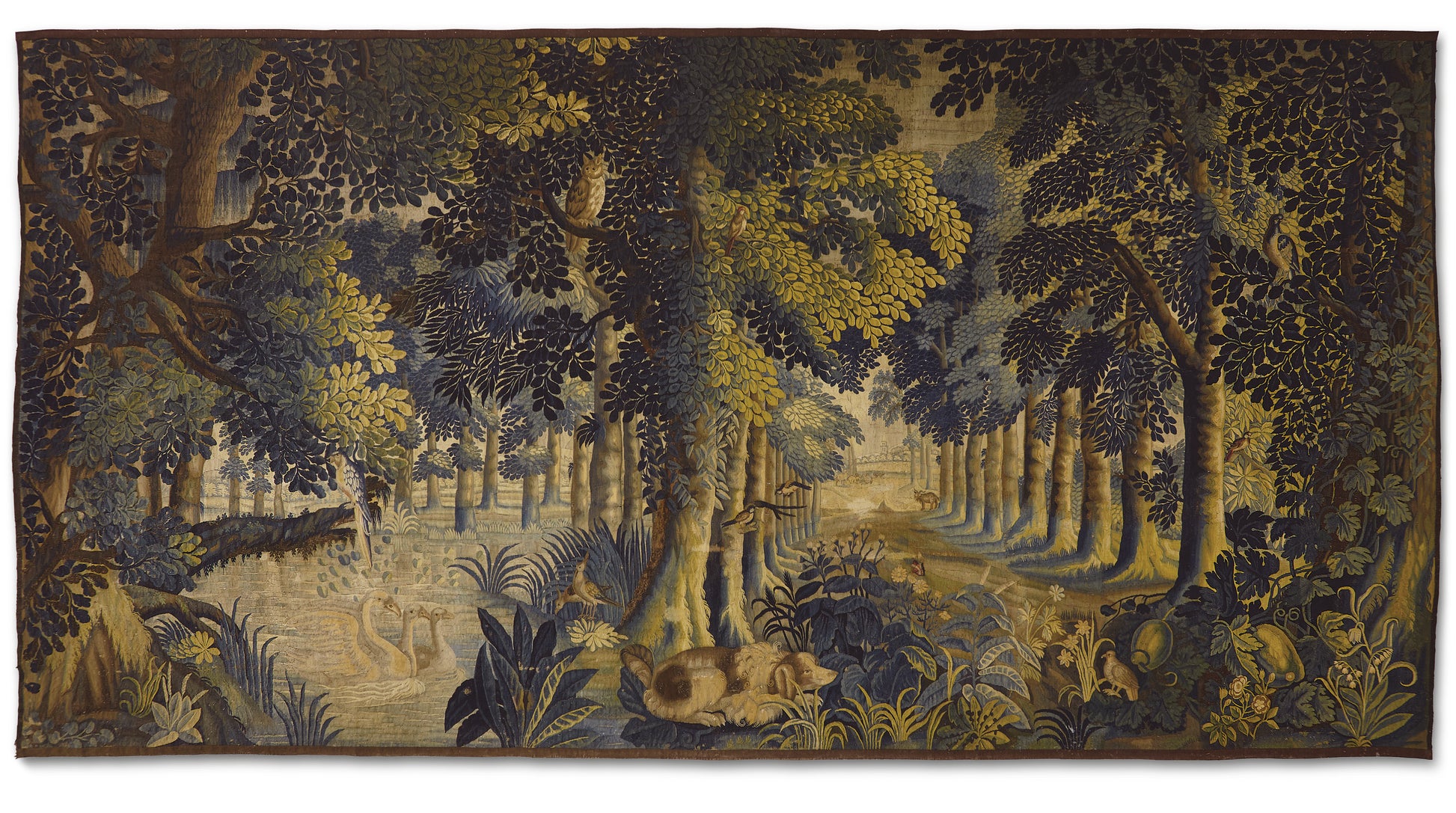 Tapestry depicting a forest scene with trees and animals