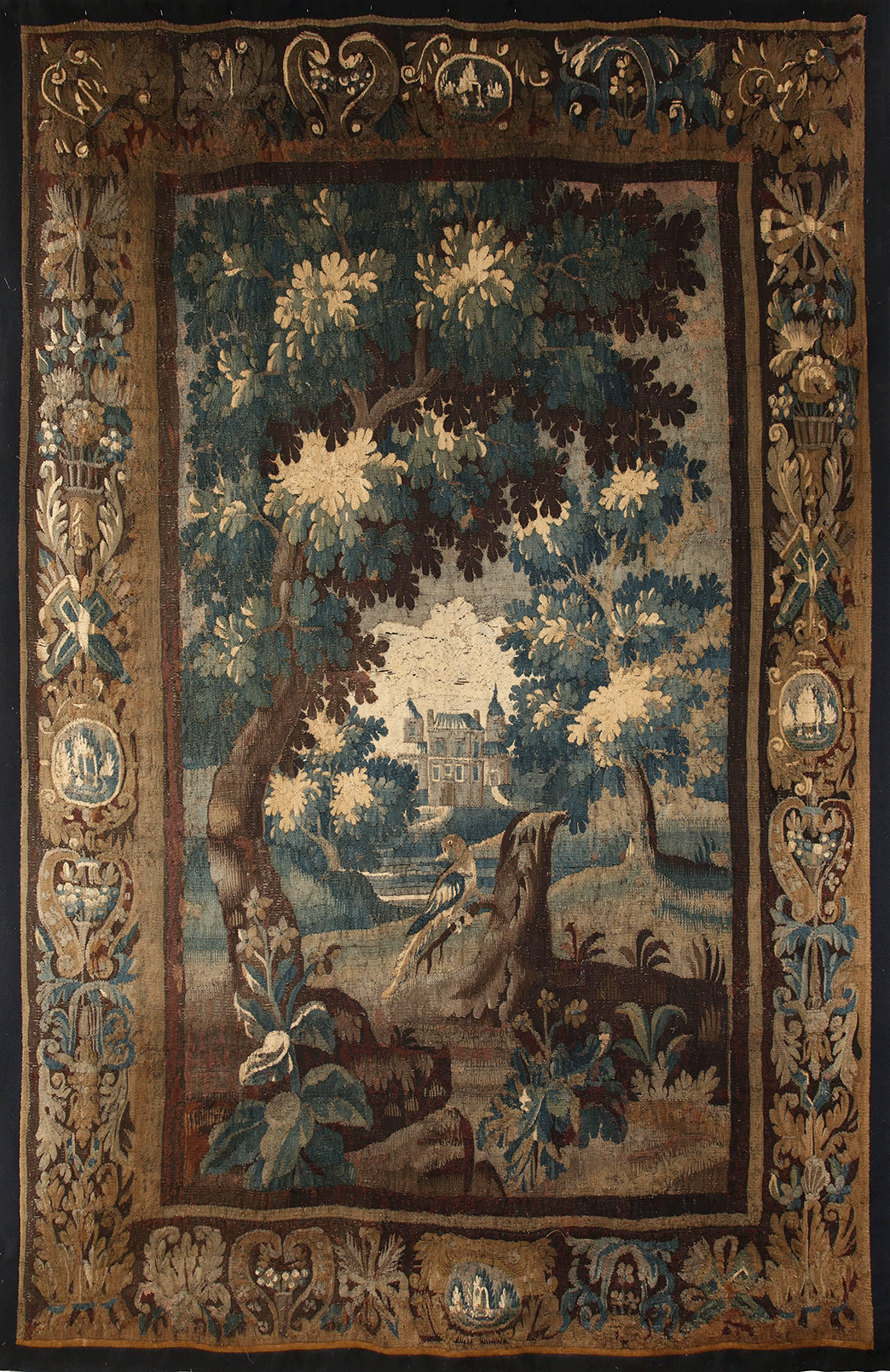 A traditional floral and landscape tapestry with a decorative border.